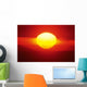 Gorgeous Sun Setting In Bright Orange Sky Over Ocean Wall Mural
