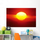 Gorgeous Sun Setting In Bright Orange Sky Over Ocean Wall Mural