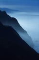 Silhouetted Cliffs Along Foggy Ocean Shoreline Wall Mural