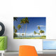 Grassy shoreline with tall palm trees Wall Mural