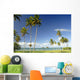 Grassy shoreline with tall palm trees Wall Mural
