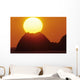 Sun Setting In Orange Sky Over Ocean And Silhouetted Hill Wall Mural