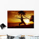 Woman Doing Yoga By The Ocean At Sunset Under Palm Tree Wall Mural