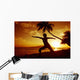 Woman Doing Yoga By The Ocean At Sunset Under Palm Tree Wall Mural