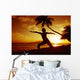 Woman Doing Yoga By The Ocean At Sunset Under Palm Tree Wall Mural