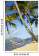 Hammock tied between palm trees on sandy beach Wall Mural