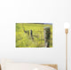 Field Of Yellow Wildflowers With A Fence Running Through It Wall Mural