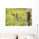 Field Of Yellow Wildflowers With A Fence Running Through It Wall Mural