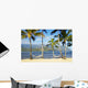 Two hammocks hanging between palm trees on sandy tropical beach Wall Mural