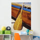 Wooden paddle and outrigger canoe on beach Wall Mural