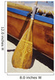 Wooden paddle and outrigger canoe on beach Wall Mural