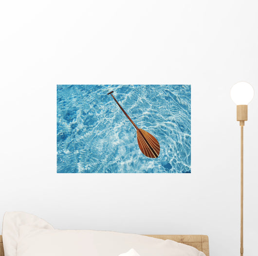 Overhead View Of Paddle Floating On Surface Of Turquoise Water Wall Mural