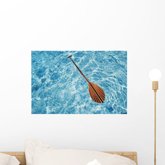 Overhead View Of Paddle Floating On Surface Of Turquoise Water Wall Mural