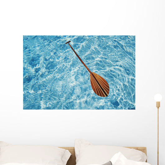 Overhead View Of Paddle Floating On Surface Of Turquoise Water Wall Mural