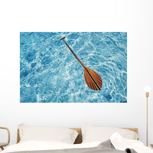 Overhead View Of Paddle Floating On Surface Of Turquoise Water Wall Mural