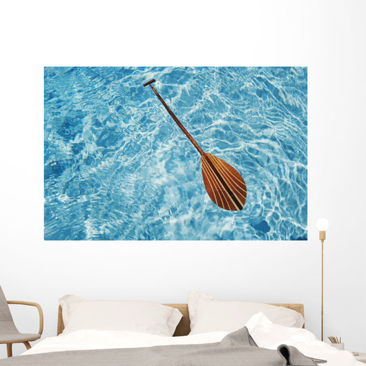 Overhead View Of Paddle Floating On Surface Of Turquoise Water Wall Mural