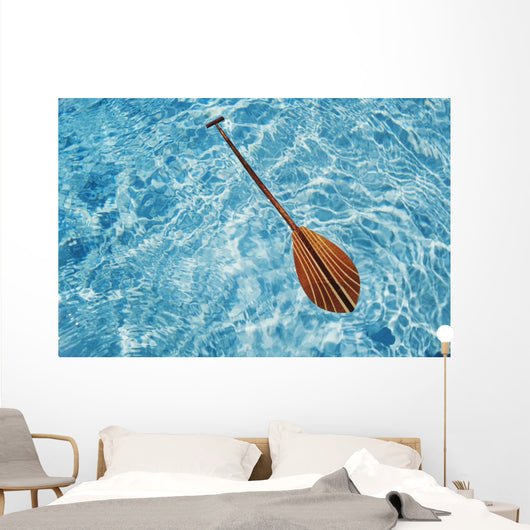 Overhead View Of Paddle Floating On Surface Of Turquoise Water Wall Mural