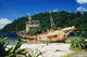 Shipwrecked fishing boat on beach Wall Mural
