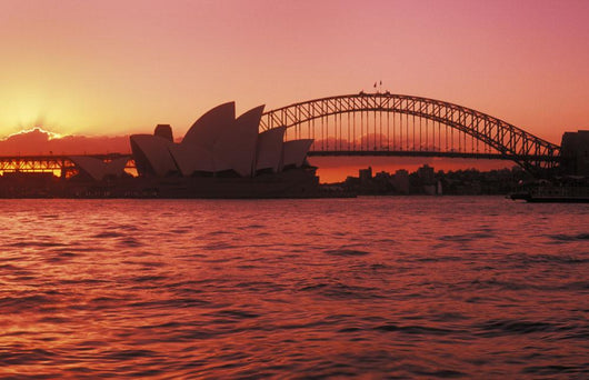 Australia, New South Wales, Opera House and Harbor Bridge at sunset Wall Mural