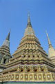 Thailand, Bangkok, Colorful Pointed Steeples Against Clear Blue Sky Wall Mural