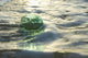 A Glass Fishing Ball Floats In Shallow Water, Bright Reflections Wall Mural