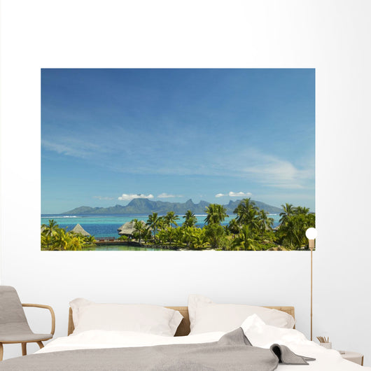 Palm Trees And Grass Huts In Foreground Wall Mural