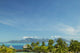 Palm Trees And Grass Huts In Foreground Wall Mural