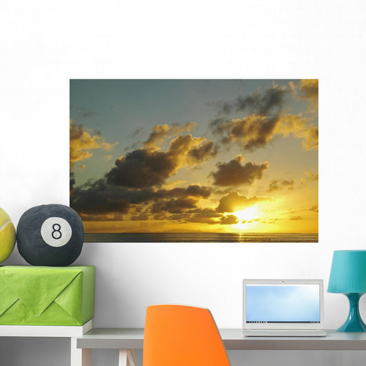 Sun Shining Through Clouds Over The Ocean At Sunset Wall Mural