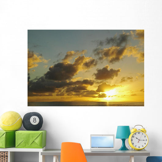 Sun Shining Through Clouds Over The Ocean At Sunset Wall Mural