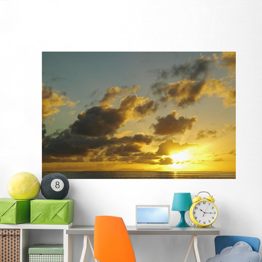 Sun Shining Through Clouds Over The Ocean At Sunset Wall Mural