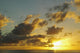 Sun Shining Through Clouds Over The Ocean At Sunset Wall Mural