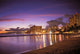 Reflection Of City Lights On The Ocean At Twilight Wall Mural