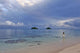Hawaii, Oahu, Lanikai, A Woman Wades In The Water At The Beach At Dusk Wall Mural