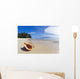 A Triton's Trumpet Shell On Sandy Beach Beside Ocean Wall Mural