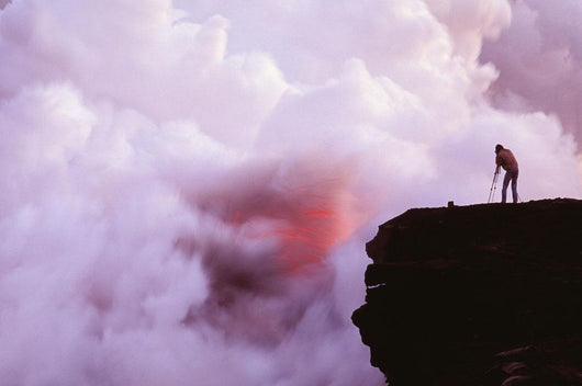 Photographer On Lava Table Filming Lava Flow Into Ocean Wall Mural
