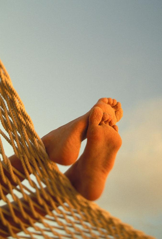 Close-Up Of Bottom Woman's Feet Crossed Wall Mural
