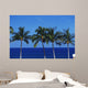 Hawaii, Palm Tree Tops Against Blue Sky And Ocean Wall Mural