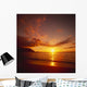 Calm Shoreline Ocean Waters With Orange Reflections From Sunset Wall Mural