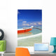 Red And White Outrigger Canoe Floating On Calm Turquoise Water Wall Mural