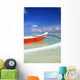 Red And White Outrigger Canoe Floating On Calm Turquoise Water Wall Mural