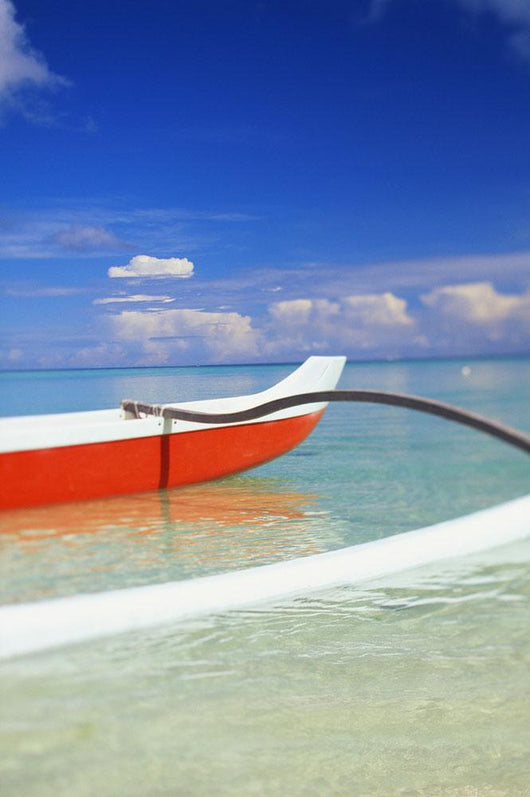 Red And White Outrigger Canoe Floating On Calm Turquoise Water Wall Mural