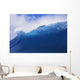Blue Wave Curling Over Forming Barrel With White Waters Wall Mural