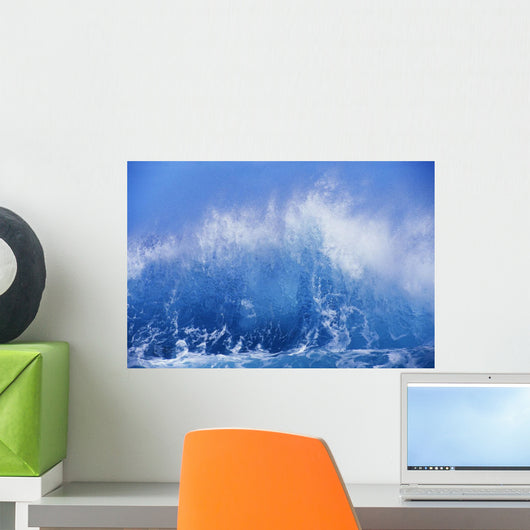 Blue Waves Crashing On The Shore With Blue Sky Background Wall Mural