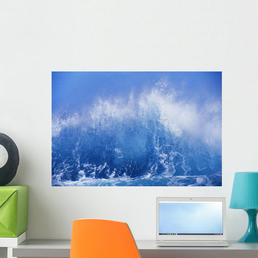 Blue Waves Crashing On The Shore With Blue Sky Background Wall Mural
