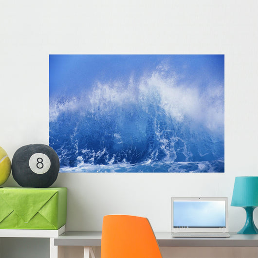 Blue Waves Crashing On The Shore With Blue Sky Background Wall Mural