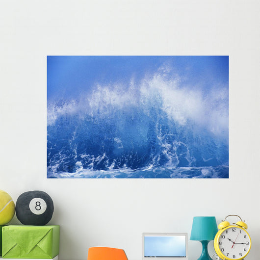 Blue Waves Crashing On The Shore With Blue Sky Background Wall Mural