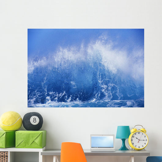 Blue Waves Crashing On The Shore With Blue Sky Background Wall Mural