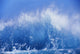 Blue Waves Crashing On The Shore With Blue Sky Background Wall Mural