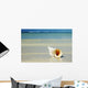 Tropical Seashell On The Beach With Gorgeous Clear Blue Ocean Behind Wall Mural