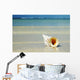 Tropical Seashell On The Beach With Gorgeous Clear Blue Ocean Behind Wall Mural